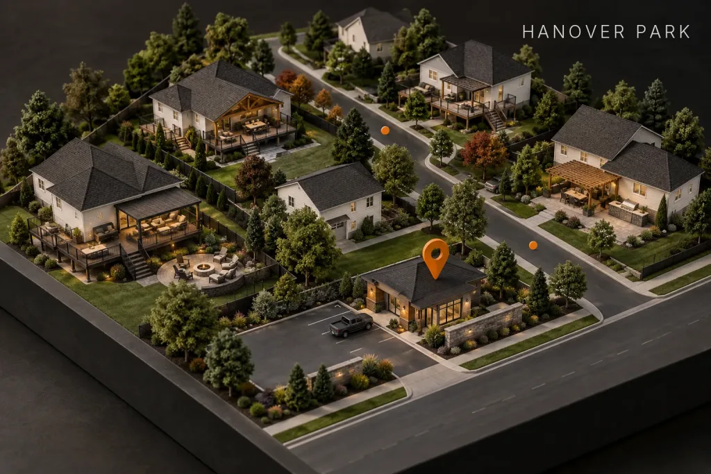 Scale model of a suburban neighborhood with decks and patios, marked by an orange map pin over a contractor's shop, labeled Hanover Park, IL
